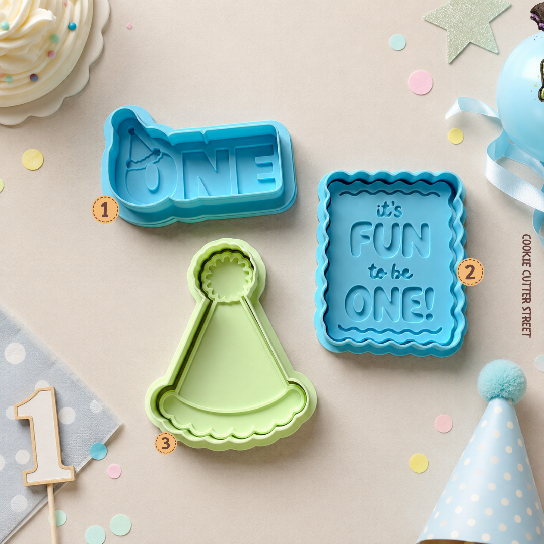First birthday raised effect icing stamps and cookie cutters featuring ONE with party hat, It's Fun to Be One and birthday party hat designs.