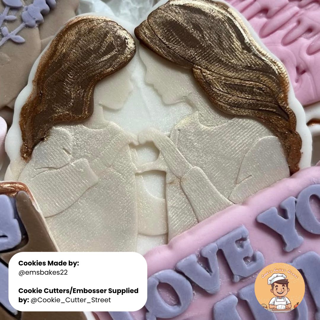 Decorative cookie with two figures and 'I love you' text, made by emsbakes22.