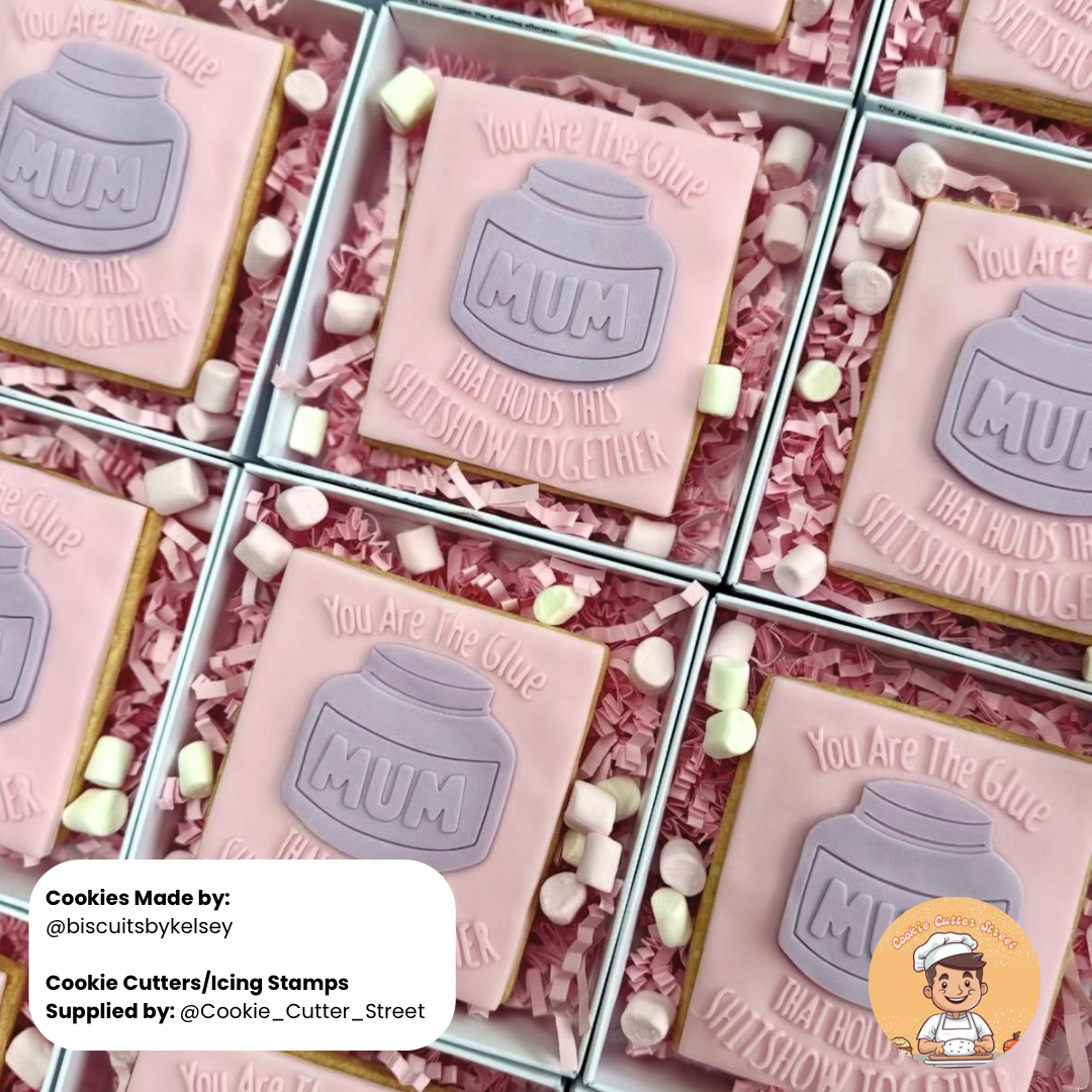 Pink cookies with 'MUM' text and jar design in a box, supplied by Cookie Cutter Street.