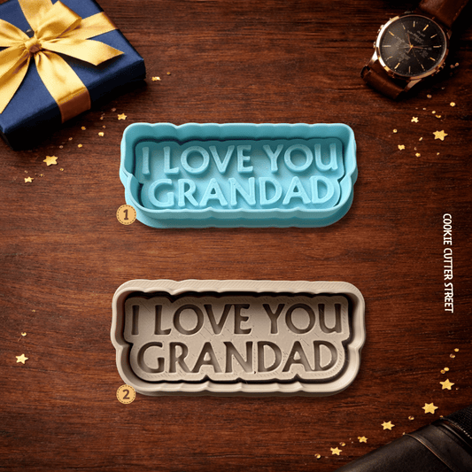 Two cookie cutters with 'I LOVE YOU GRANDAD' text on a wooden surface with decorative elements.