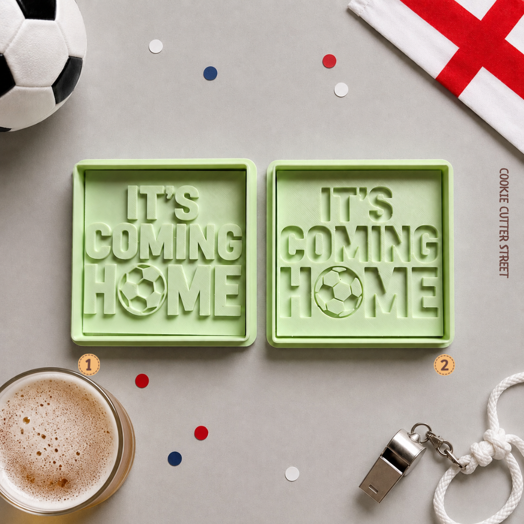 Two green cookie cutters with 'It's Coming Home' text on a table with a soccer ball, coffee, and confetti.