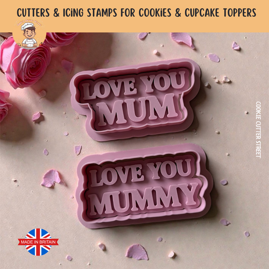 Pink cookie cutters with 'LOVE YOU MUM' and 'LOVE YOU MUMMY' text on a decorative background.