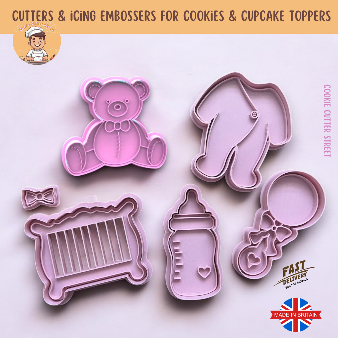A set of six baby-themed cookie cutters and embossers, including a teddy bear, baby grow, crib, milk bottle, baby rattle with bow, and a mini bow, perfect for baby showers and celebrations.