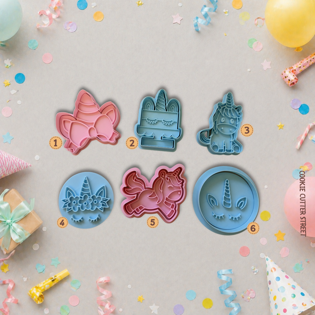 Set of colourful unicorn cookie cutters with decorative items on a light gray background
