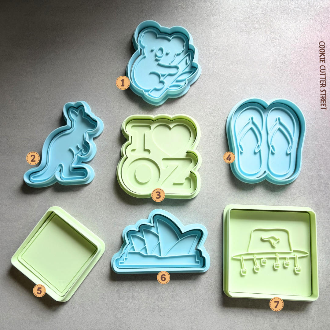 Australian-themed cookie stamps featuring koala, kangaroo, Sydney Opera House, G’Day, boomerang and personalised warning sign designs for emigration and travel celebrations.