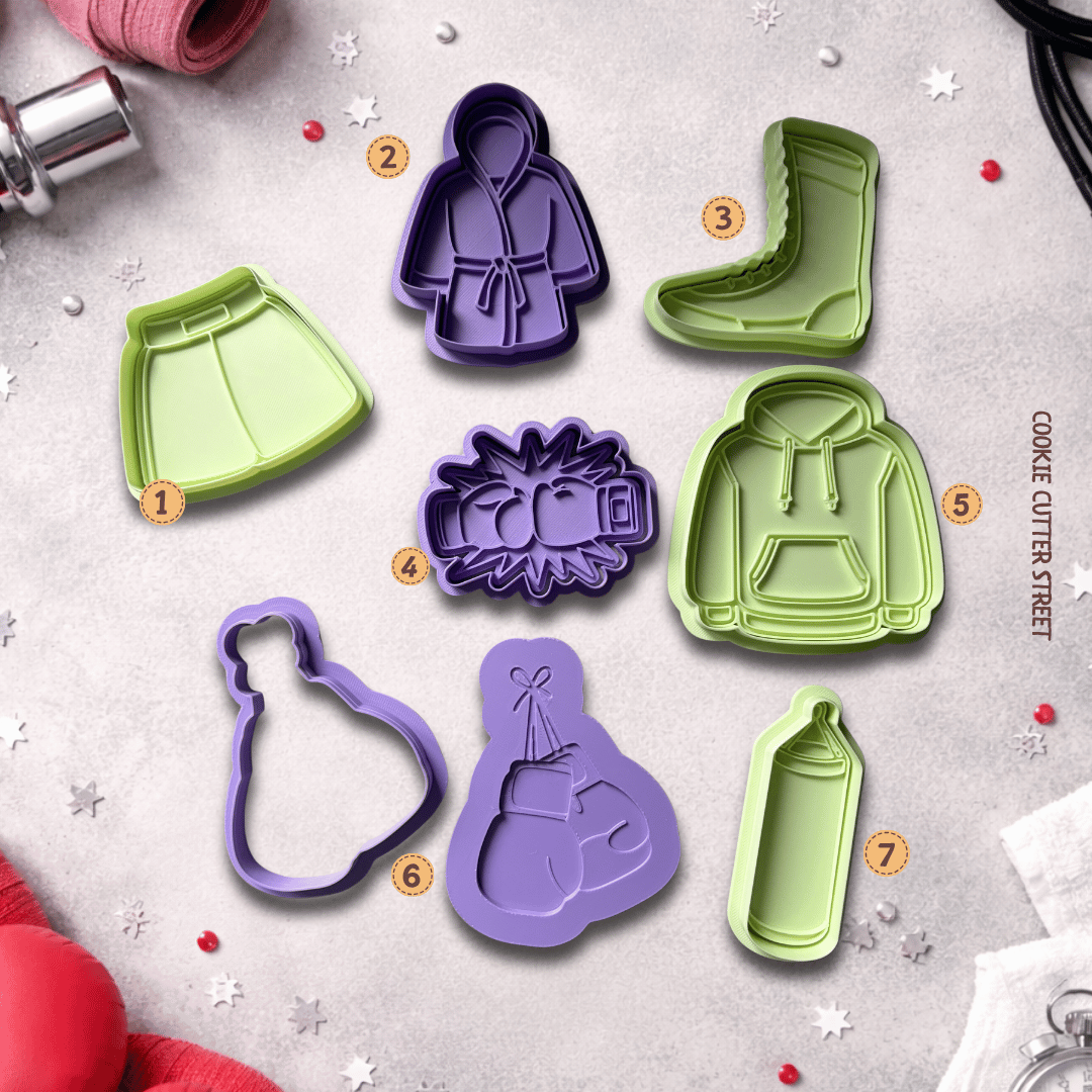 Set of boxing themed cookie cutters and stamps including gloves, robe, boot, hoodie and punch bag designs on a styled background.