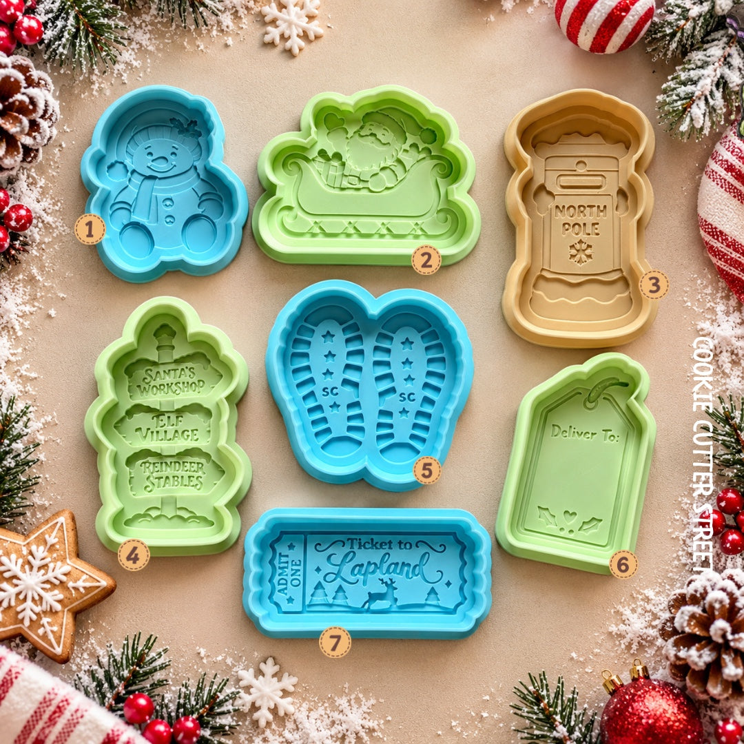 Christmas Lapland multi-level icing stamps and cookie cutters featuring snowman, Santa sleigh, North Pole postbox, Christmas signpost, Santa footprints, gift tag and Lapland ticket.