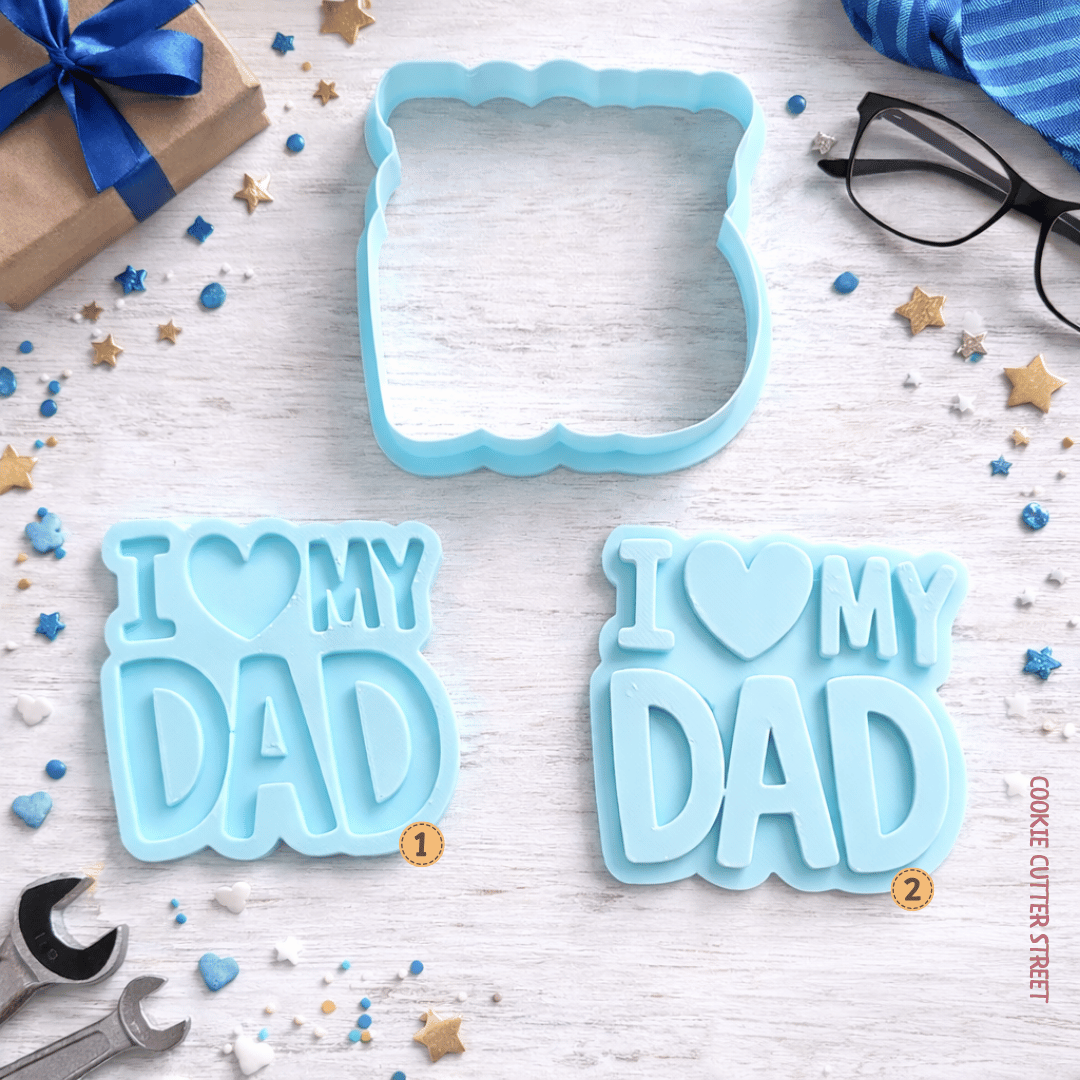 Blue “I Love My Dad” cookie stamp and cutter set shown with raised and imprint design options on a styled background.