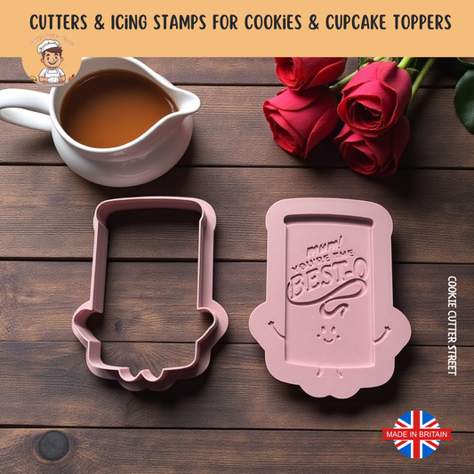 Mothers Day You're the besto gravy Two pink cookie cutters on a wooden surface with tea and roses.