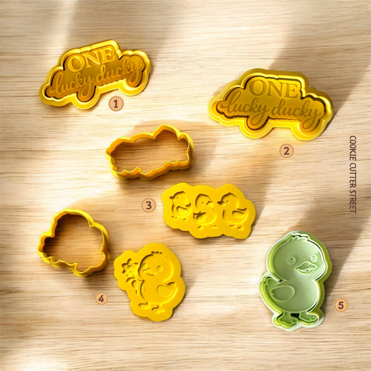 One Lucky Ducky cookie stamp and cutter set with duck designs and text embossers, perfect for baby showers and first birthday themed cookies.