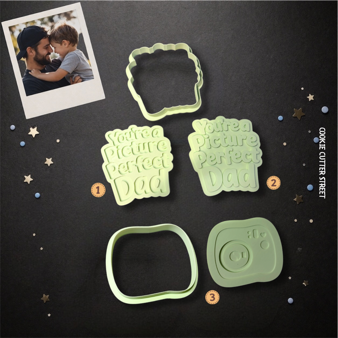 Green cookie cutter and stamp set featuring “You’re a Picture Perfect Dad” text in raised and imprint styles alongside a Polaroid camera cutter.
