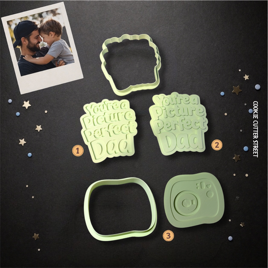 Green cookie cutter and stamp set featuring “You’re a Picture Perfect Dad” text in raised and imprint styles alongside a Polaroid camera cutter.
