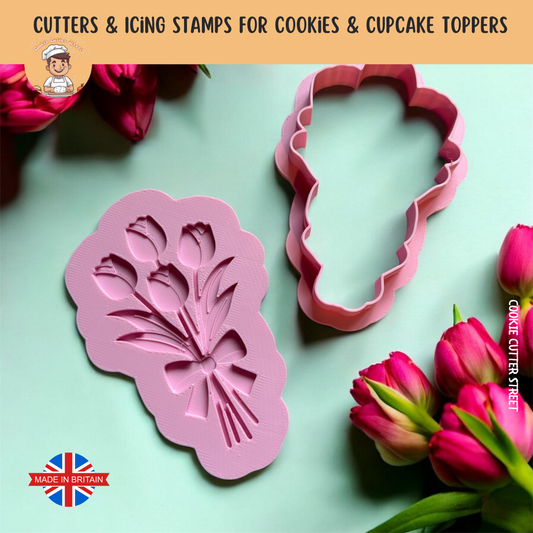 Tulip cookie cutters with floral designs on a light green background with pink tulips.